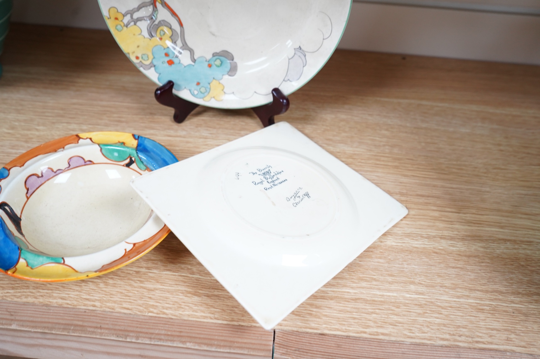 An early 20th century Clarice Cliff Bermuda pattern plate, Blue Autumn bowl and a Coral Firs Bizarre side plate, largest 23cm in diameter